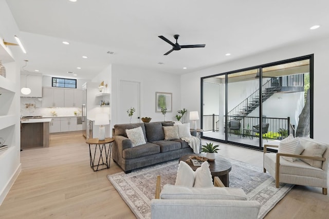living area featuring light wood-style floors, recessed lighting, and ceiling fan