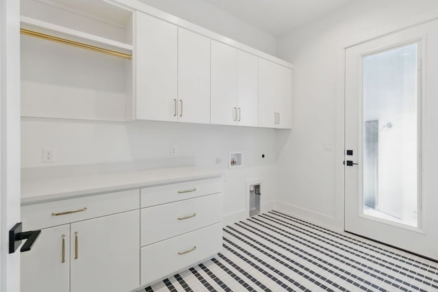 washroom featuring cabinet space, hookup for an electric dryer, washer hookup, and plenty of natural light