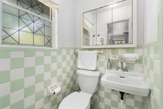 4819 Roundup Trl, Austin, TX 78745 - half bathroom featuring toilet, tile walls, and a sink