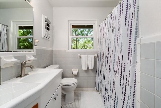 4819 Roundup Trl, Austin, TX 78745 - full bath with toilet, tile patterned floors, tile walls, vanity, and wainscoting