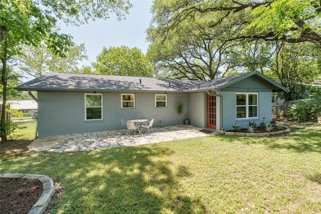 4819 Roundup Trl, Austin, TX 78745 - rear view of house featuring brick siding, a patio, and roof with shingles