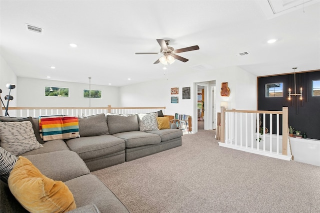 carpeted living area with attic access, a ceiling fan, and recessed lighting