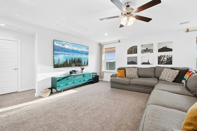 carpeted living room with ceiling fan, attic access, baseboards, and recessed lighting