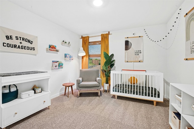 carpeted bedroom with a nursery area and baseboards