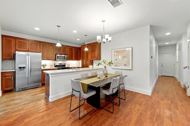 610 Fletcher St Unit A, Austin, TX 78704 - dining room featuring light wood-style flooring, a chandelier, baseboards, and recessed lighting