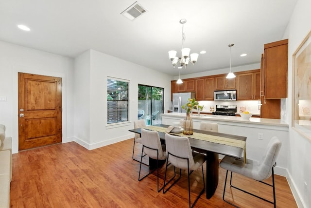 610 Fletcher St Unit A, Austin, TX 78704 - dining room with a chandelier, recessed lighting, baseboards, and light wood finished floors