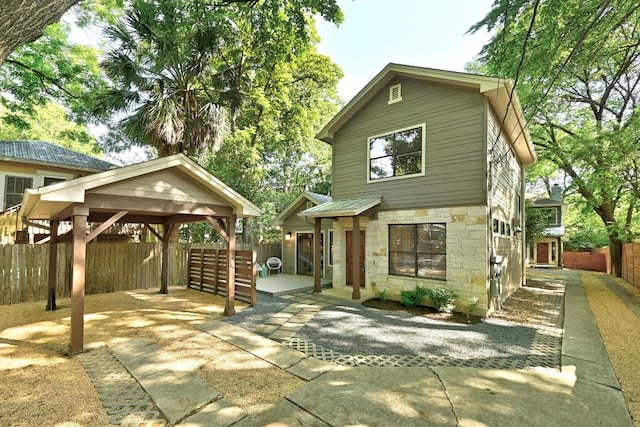610 Fletcher St Unit A, Austin, TX 78704 - view of front of house featuring stone siding, a gazebo, a patio, and metal roof