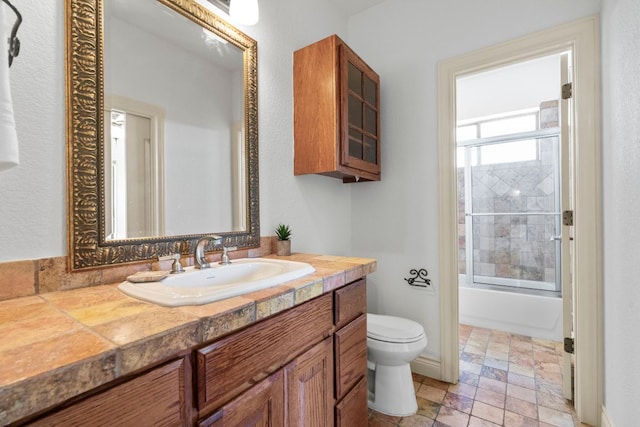 432 Stacey Ann Cv, Dripping Springs, TX 78620 - bathroom with vanity, bath / shower combo with glass door, and stone finish floors