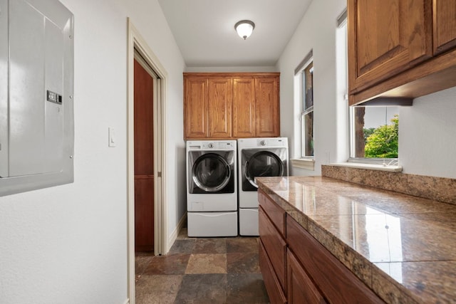 432 Stacey Ann Cv, Dripping Springs, TX 78620 - laundry area featuring electric panel, washing machine and dryer, stone finish floors, and cabinet space