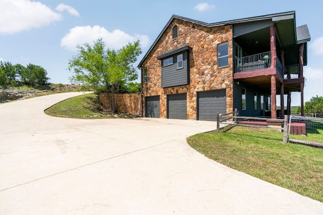 432 Stacey Ann Cv, Dripping Springs, TX 78620 - view of front of home featuring stone siding, a balcony, concrete driveway, and an attached garage
