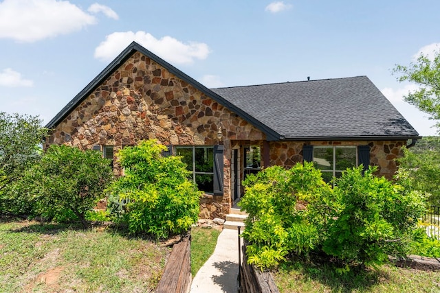 432 Stacey Ann Cv, Dripping Springs, TX 78620 - tudor-style house featuring stone siding and a shingled roof