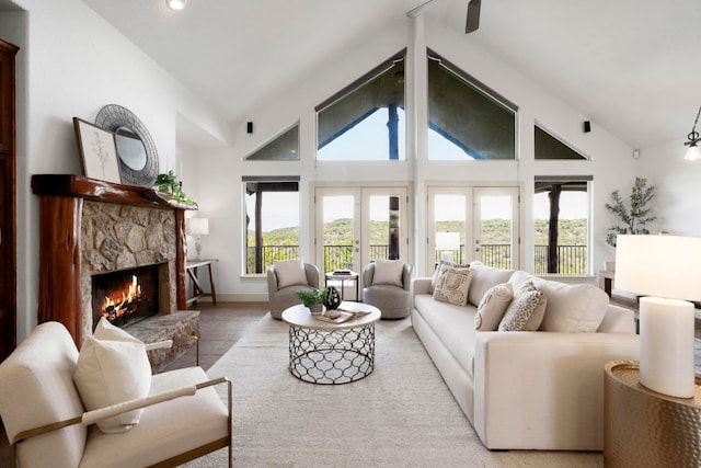 432 Stacey Ann Cv, Dripping Springs, TX 78620 - living room featuring a stone fireplace, french doors, high vaulted ceiling, and recessed lighting