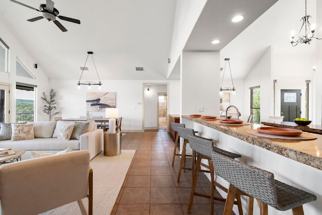 432 Stacey Ann Cv, Dripping Springs, TX 78620 - living area with high vaulted ceiling, tile patterned floors, ceiling fan, a chandelier, and recessed lighting