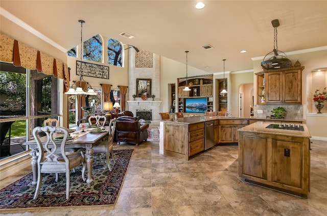 kitchen with stainless steel dishwasher, arched walkways, open floor plan, stovetop, and a fireplace