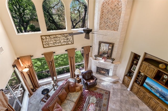 105 Hill Valley Cv, Georgetown, TX 78628 - living room with a high ceiling, a fireplace, and a ceiling fan