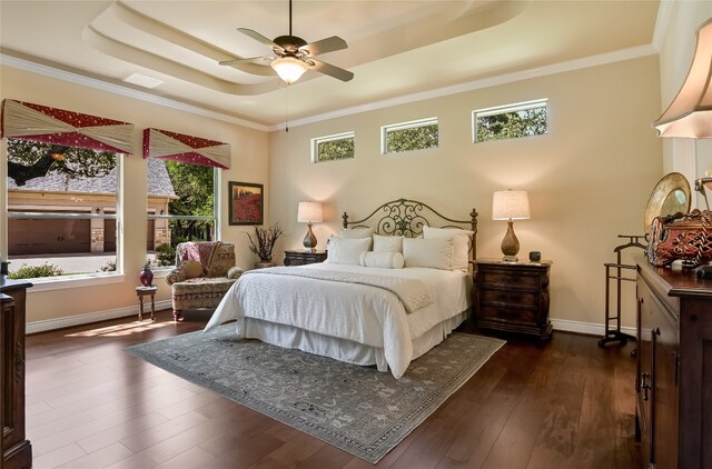 105 Hill Valley Cv, Georgetown, TX 78628 - bedroom with a raised ceiling, dark wood finished floors, baseboards, and a ceiling fan