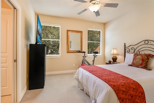 105 Hill Valley Cv, Georgetown, TX 78628 - bedroom featuring light carpet, multiple windows, baseboards, and a ceiling fan