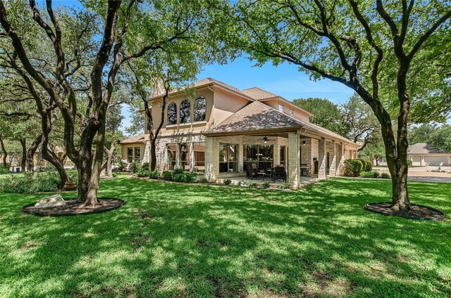 105 Hill Valley Cv, Georgetown, TX 78628 - back of house with ceiling fan, a patio, a lawn, and stucco siding