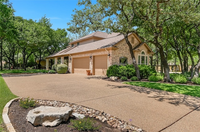 105 Hill Valley Cv, Georgetown, TX 78628 - view of front of property featuring a garage, brick siding, driveway, and a shingled roof