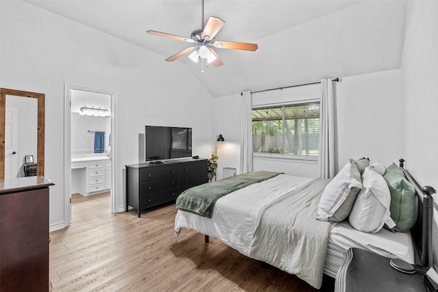 bedroom with vaulted ceiling, light wood-type flooring, ensuite bath, and a ceiling fan