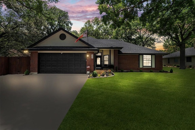 ranch-style home featuring an attached garage, concrete driveway, and brick siding
