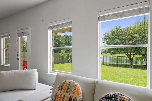 interior space featuring healthy amount of natural light and a water view