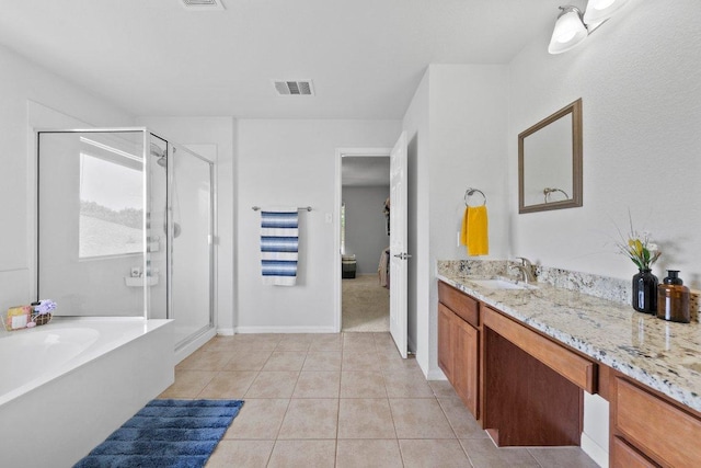 bathroom with vanity, tile patterned flooring, a garden tub, and a stall shower