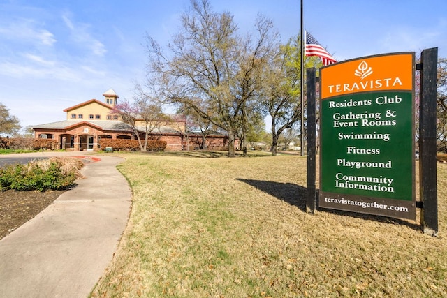 view of home's community with a yard