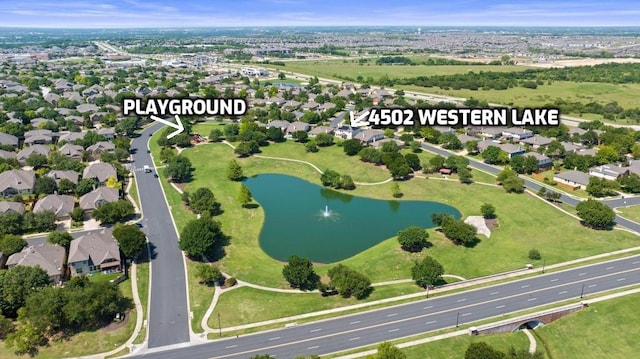 aerial view of property and surrounding area featuring a nearby body of water and nearby suburban area