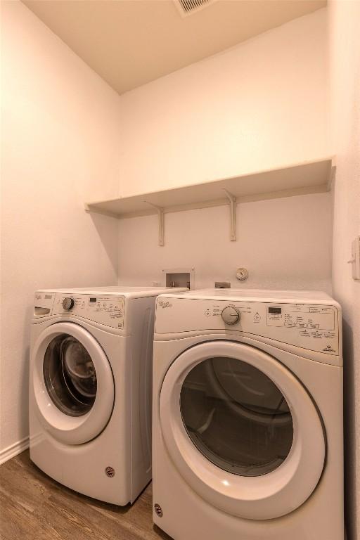 9005 Pin Brush Dr, Austin, TX 78748 - washroom with wood finished floors, washing machine and dryer, and baseboards