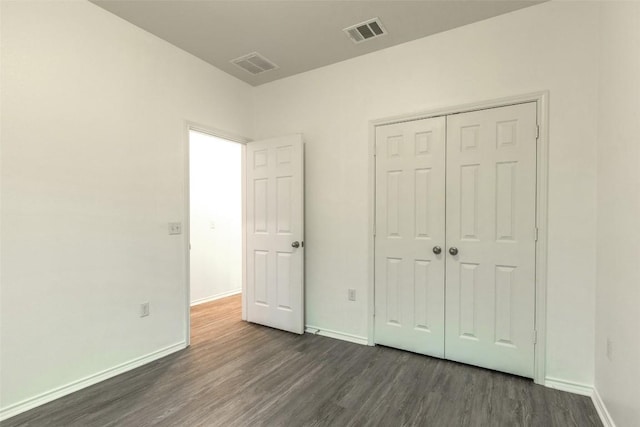 9005 Pin Brush Dr, Austin, TX 78748 - unfurnished bedroom featuring dark wood-type flooring, baseboards, and a closet