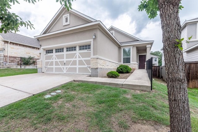 9005 Pin Brush Dr, Austin, TX 78748 - view of front of home featuring stucco siding, stone siding, driveway, and a garage