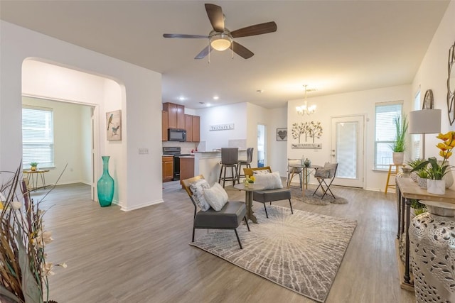 9005 Pin Brush Dr, Austin, TX 78748 - living room with light wood-style flooring, baseboards, healthy amount of natural light, and a chandelier