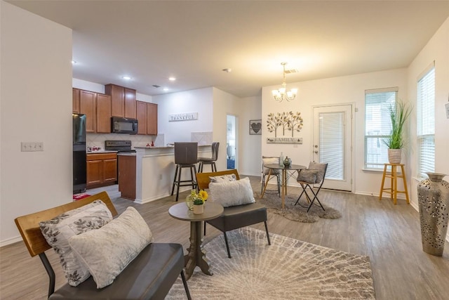 9005 Pin Brush Dr, Austin, TX 78748 - living room with a chandelier, wood finished floors, baseboards, and recessed lighting