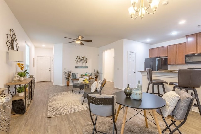 9005 Pin Brush Dr, Austin, TX 78748 - dining area with light wood-type flooring, ceiling fan, baseboards, a chandelier, and recessed lighting