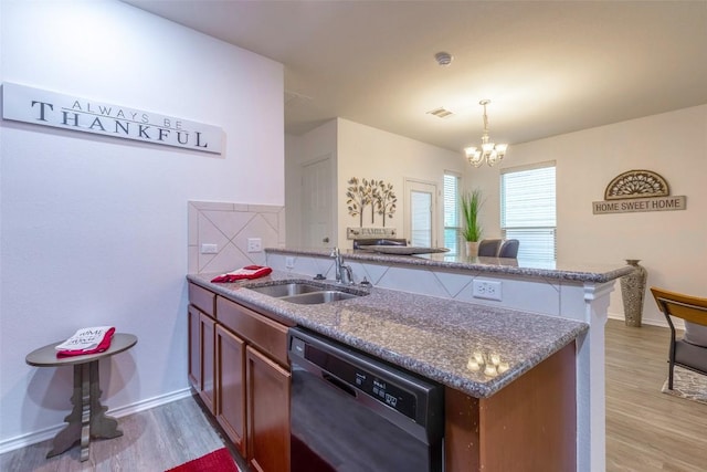 9005 Pin Brush Dr, Austin, TX 78748 - kitchen featuring dishwasher, a sink, a peninsula, and light wood-style flooring