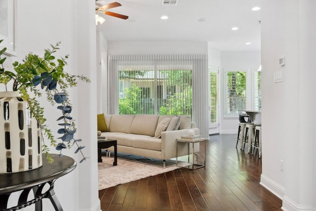 living room featuring plenty of natural light, ceiling fan, dark wood finished floors, baseboards, and recessed lighting