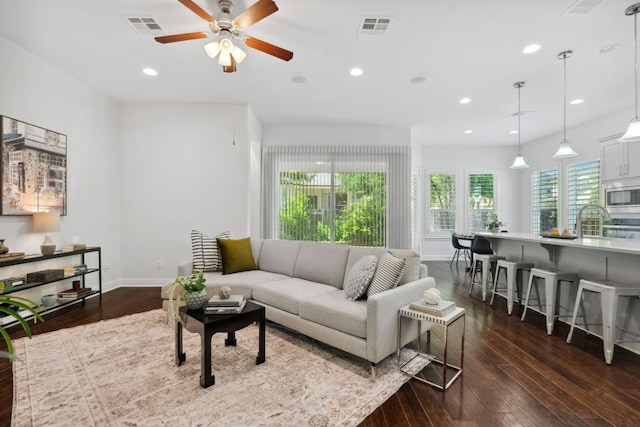 living area featuring ceiling fan, dark wood-style flooring, baseboards, and recessed lighting