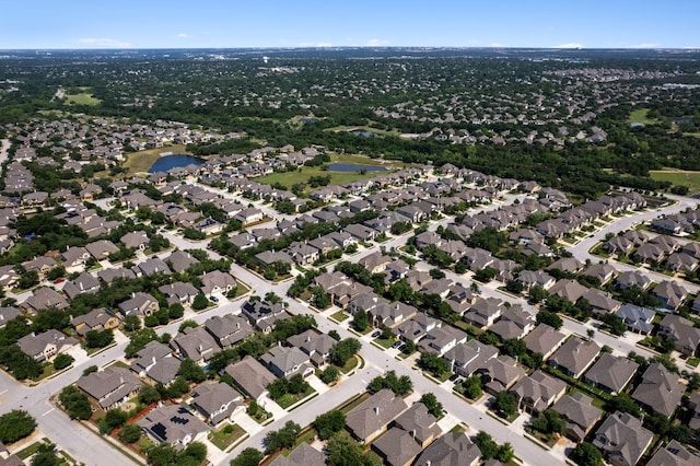 aerial overview of property's location featuring a nearby body of water and nearby suburban area