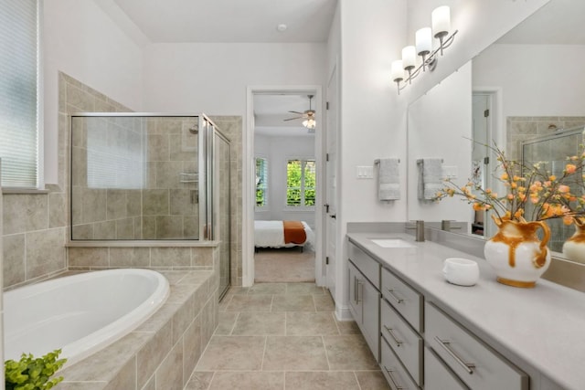 ensuite bathroom with vanity, ceiling fan, a stall shower, and a garden tub