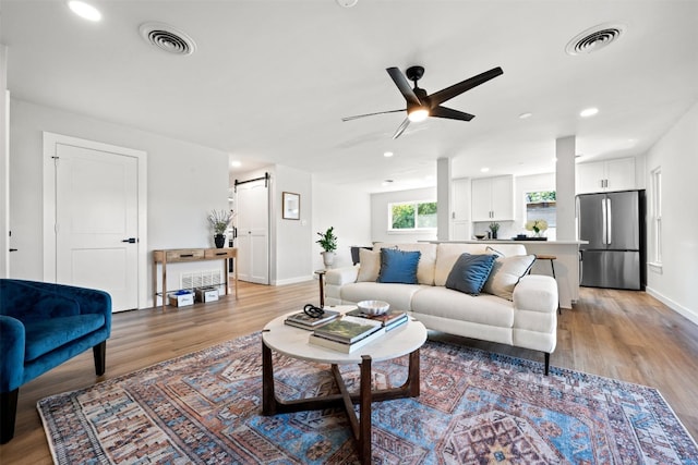 616 Bissonet Ln, Austin, TX 78752 - living room featuring a ceiling fan, light wood-type flooring, and recessed lighting