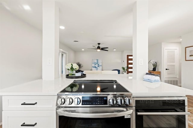 616 Bissonet Ln, Austin, TX 78752 - kitchen with appliances with stainless steel finishes, white cabinets, ceiling fan, light countertops, and open floor plan