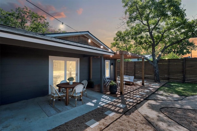 616 Bissonet Ln, Austin, TX 78752 - patio terrace at dusk featuring a patio area, a fenced backyard, and a pergola