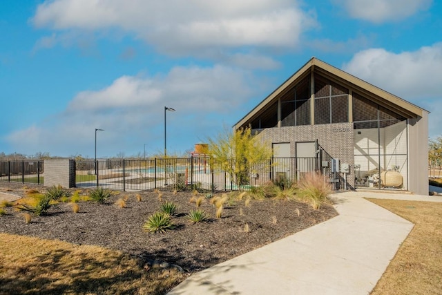 view of community with fence and a pool