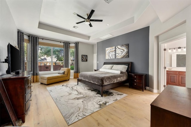 905 S Frontier Ln, Cedar Park, TX 78613 - bedroom with a raised ceiling, light wood finished floors, baseboards, and ceiling fan