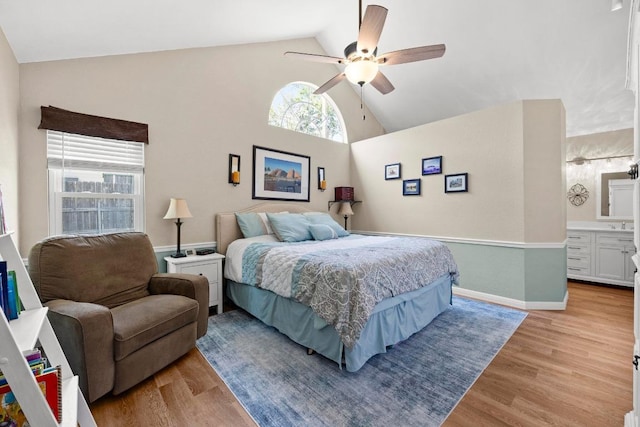 bedroom with light wood-style flooring, high vaulted ceiling, ceiling fan, and baseboards