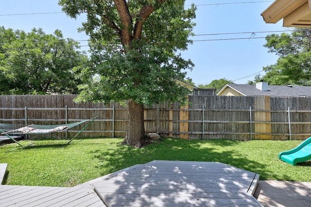 view of yard featuring a playground and a wooden deck