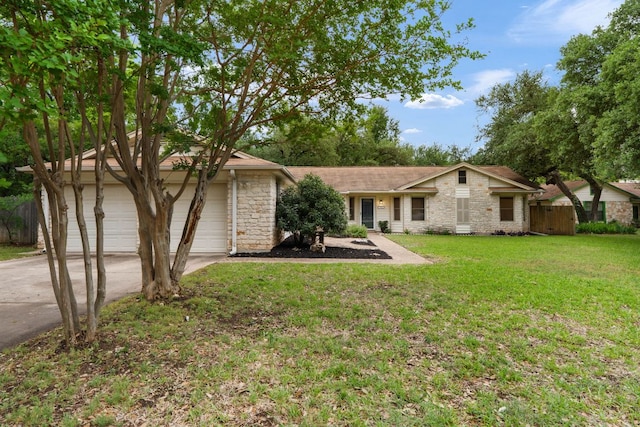ranch-style house featuring concrete driveway, stone siding, and an attached garage