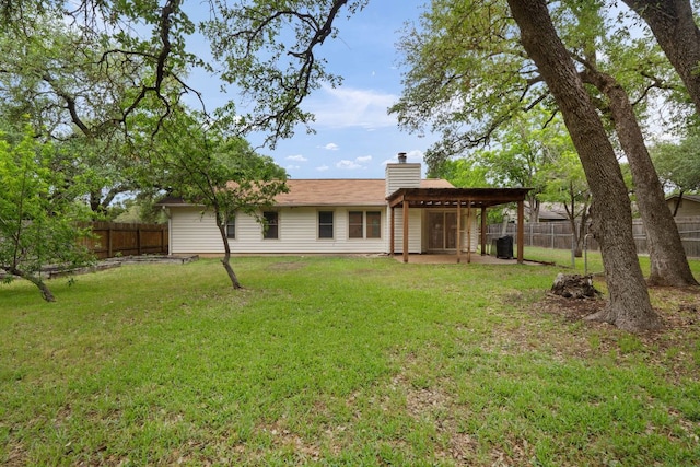 back of property featuring a chimney and a patio area