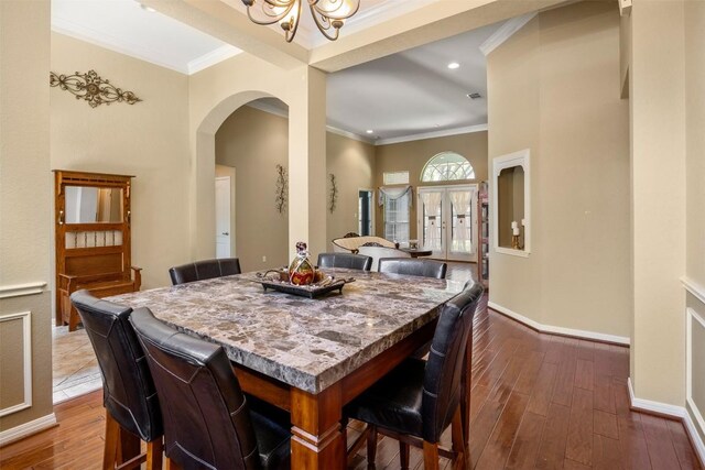 2025 Saint Andrews Dr, Round Rock, TX 78664 - dining area featuring arched walkways, crown molding, dark wood-type flooring, baseboards, and recessed lighting